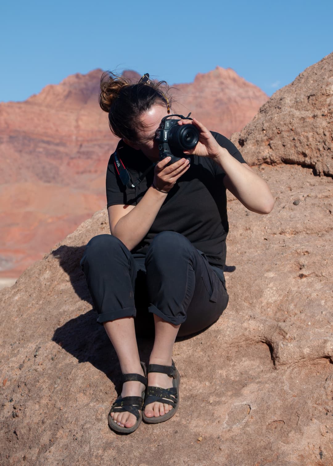 photographer laying on mountainside