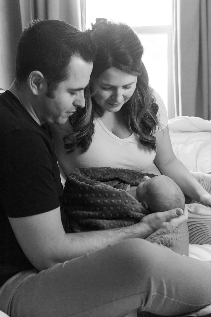 mom and dad holding newborn